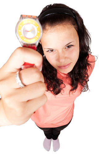 Picture of a woman pointing to her watch as if you were late. Typical management or customer reaction to delayed software projects
